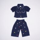 Justtots A chic two-piece navy blue textured cotton set featuring a stitch-detailed button-down shirt and matching floral embroidered trousers with tassel pockets.