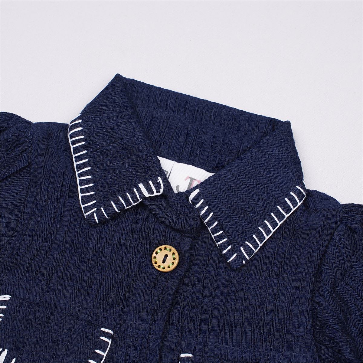 Justtots A chic two-piece navy blue textured cotton set featuring a stitch-detailed button-down shirt and matching floral embroidered trousers with tassel pockets.
